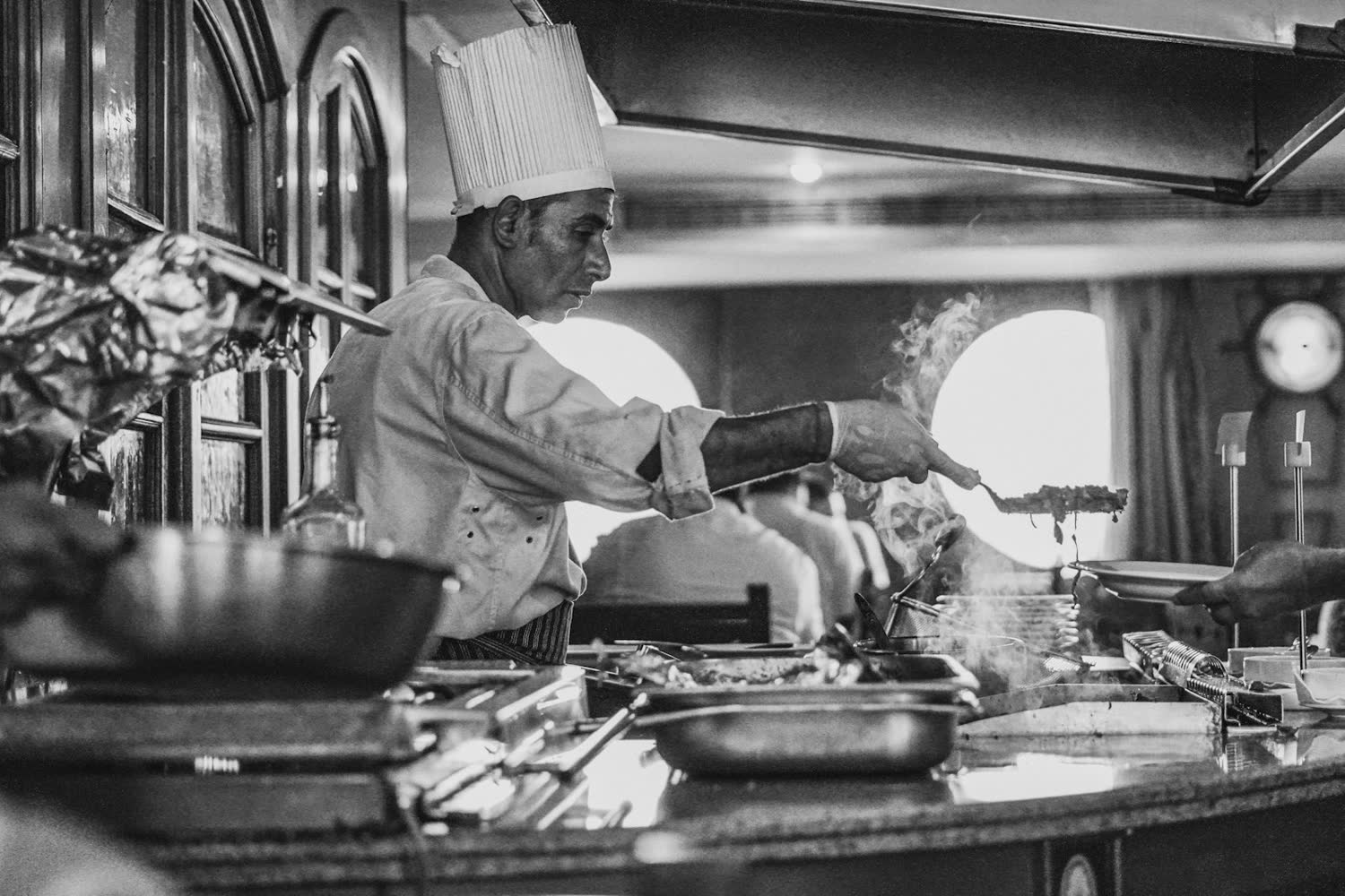 A chef working the pass in the open kitchen